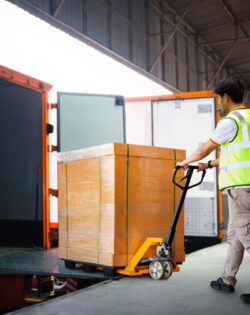 workers unloading heavy pallet boxes into container truck supply chain shipment warehouse shipping 1